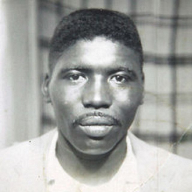 Black and white photo of a young black man.
