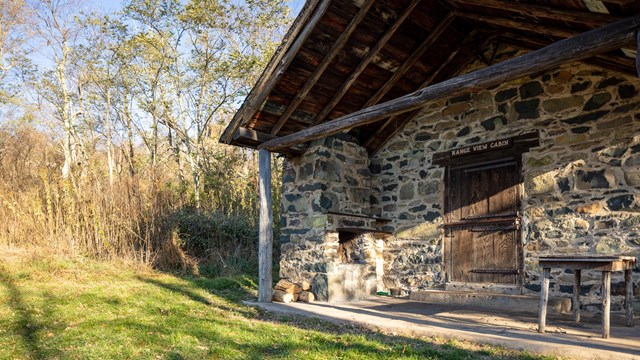 Stone cabin with a sign reading "Range View"
