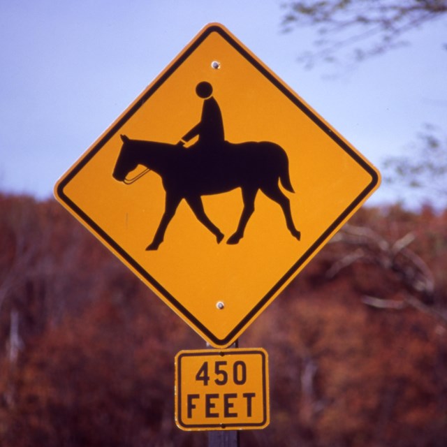 A sign for horse crossing.