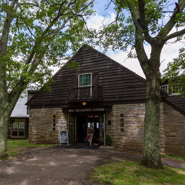 Big Meadows Lodge, an historic wood and stone building surrounded by trees.