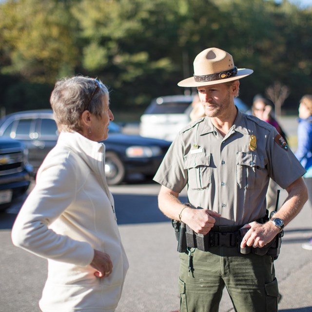 Law enforcement park ranger speaking with a visitor