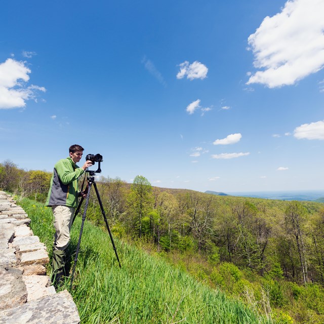 Visitor taking photo at an overlook