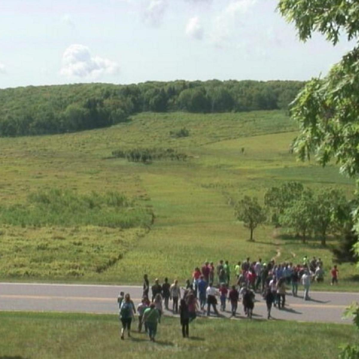 A crowd crossing Skyline drive into Big Meadows.