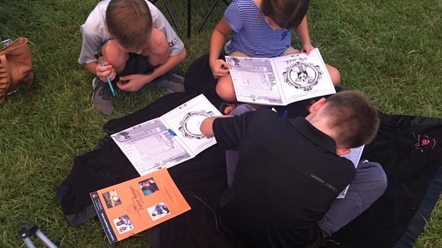 Image of children working on Junior Ranger booklets. 