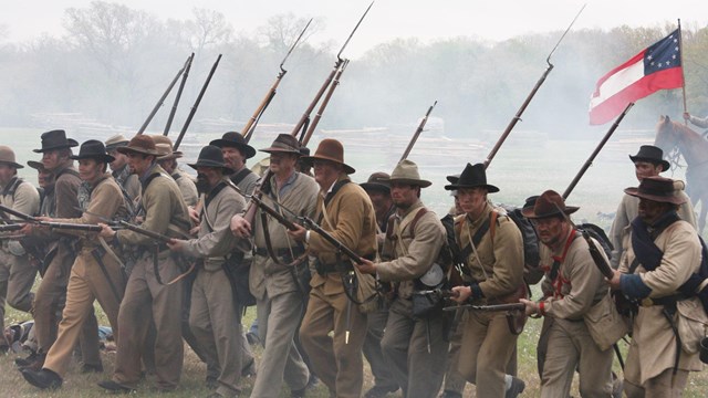 Soldiers marching forward in formation. 