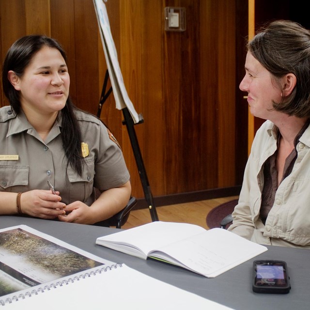Park ranger and women having a formal meeting at a table