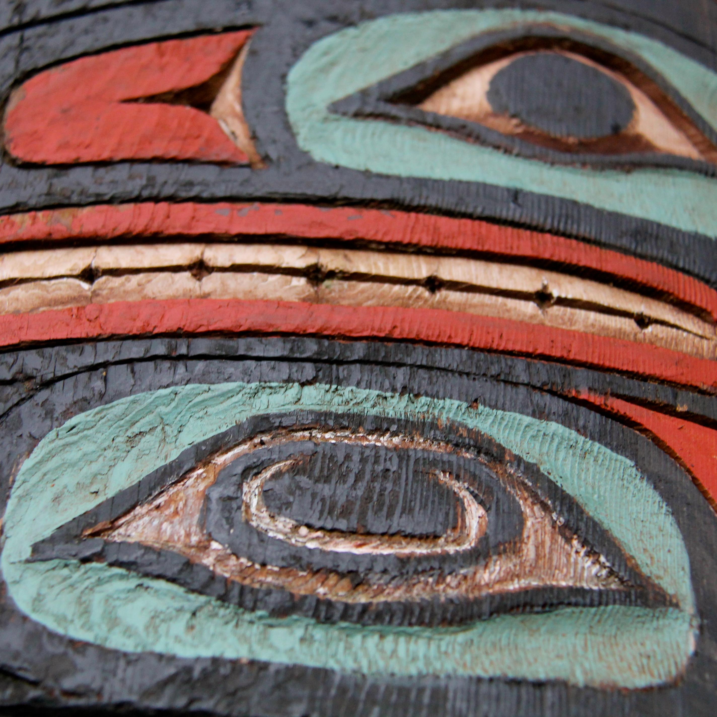 A close up of a totem carving