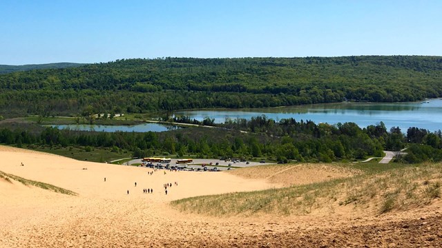 View of a large sand dune with a small lake beyond