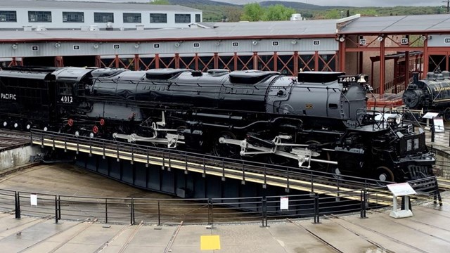 Steam locomotive with a light dusting of snow amid snow flurries