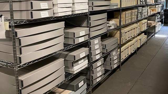 Large racks filled with boxes in a museum storage area. 