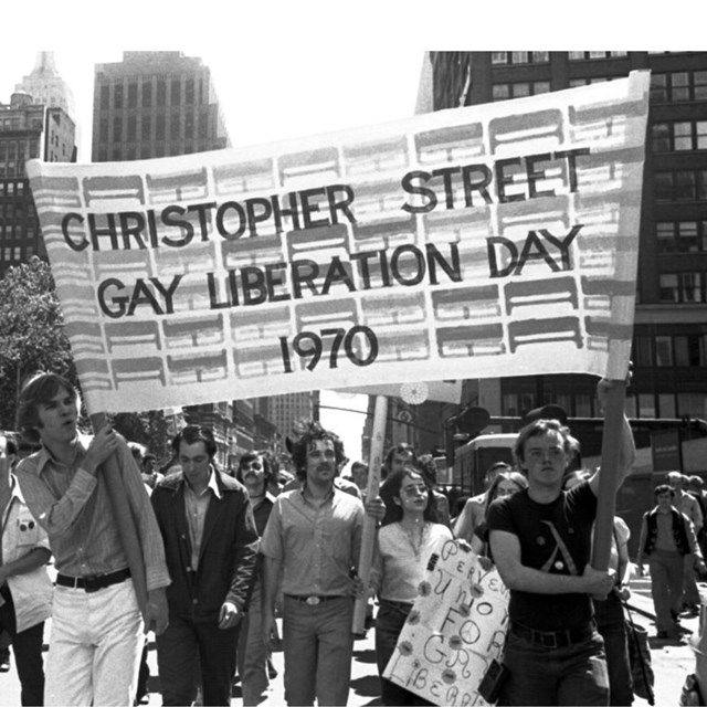 People holding a banner that says 