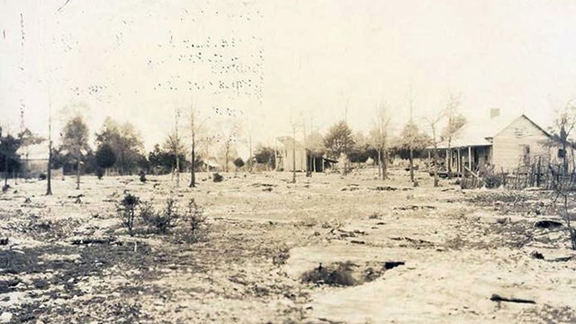 A small shack sits is rock strewn field.