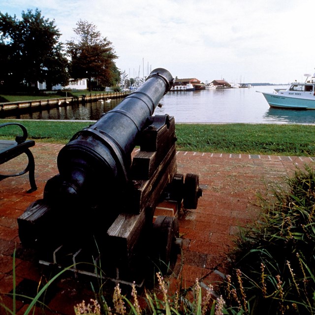 A cannon overlooks the water. 