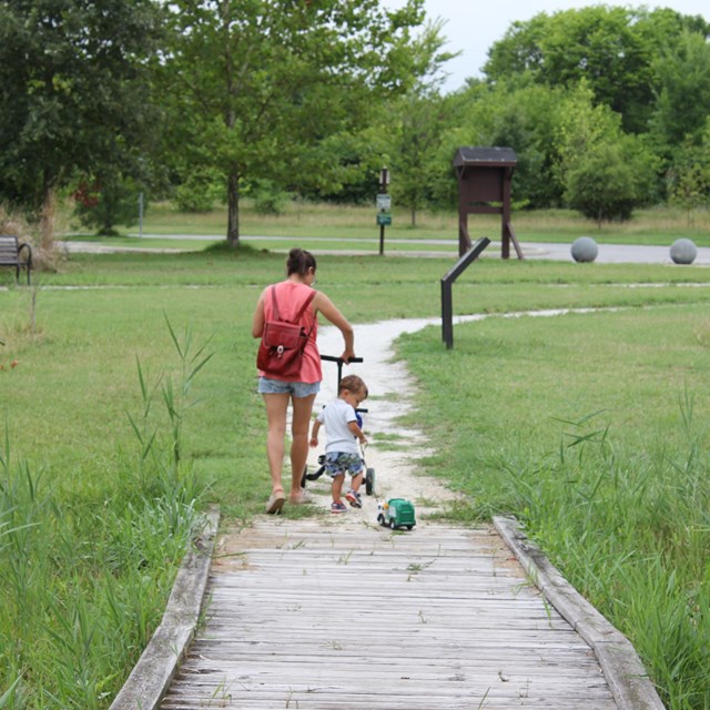 Visitors walking along boardwalk at North Point State Battlefield.