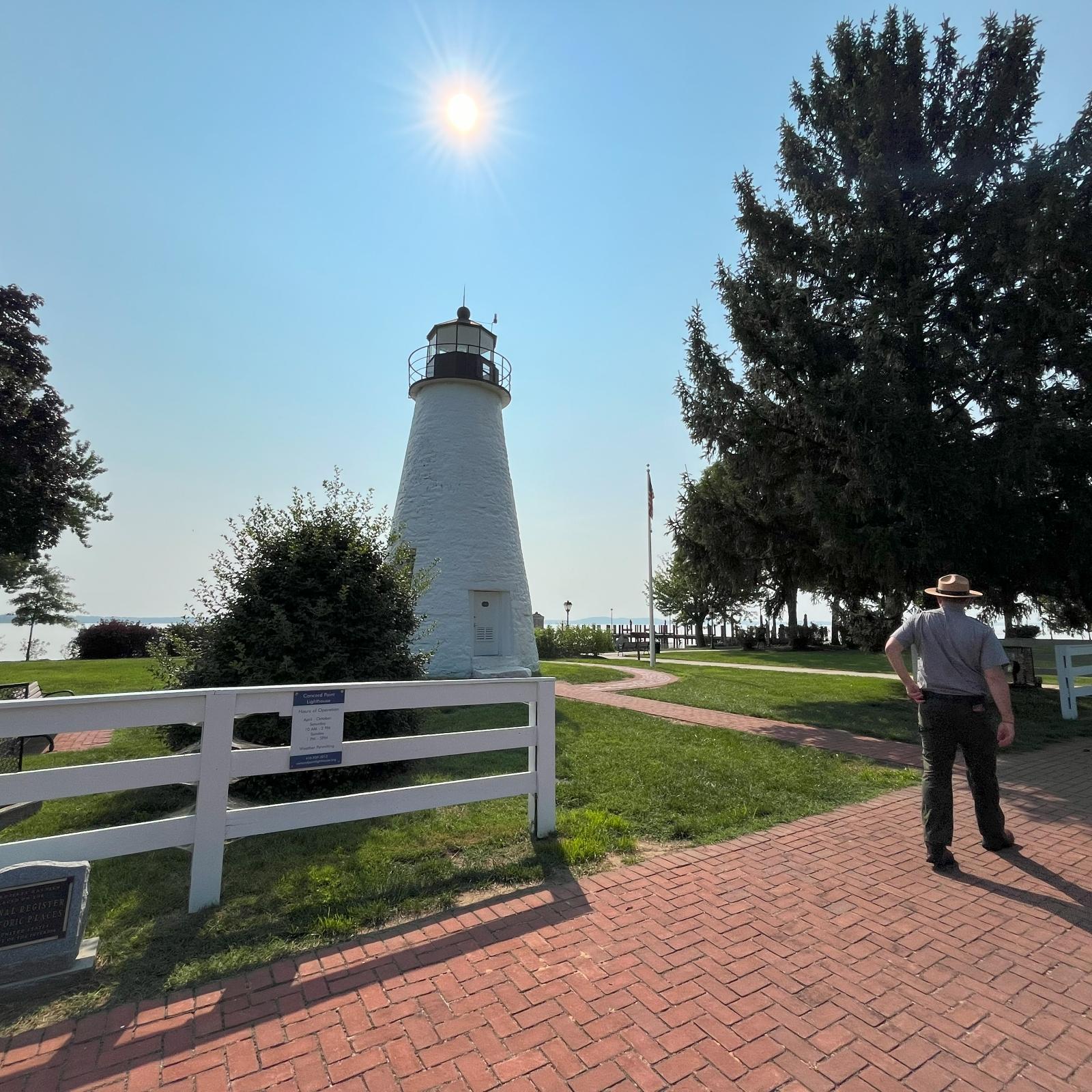 Ranger standing near the Concord Point Lighthouse in Havre de Grace; NPS