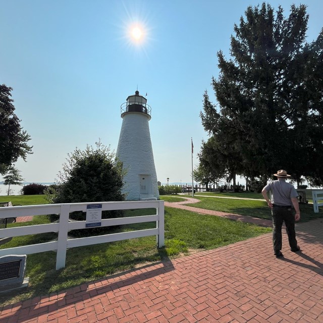 Ranger standing near the Concord Point Lighthouse in Havre de Grace; NPS