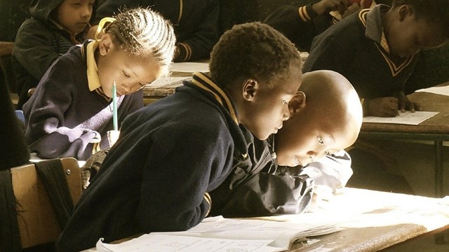 Children looking at a book. 