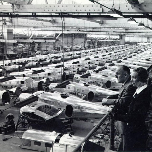 Black and white overhead photo of airplanes lined up in hangar