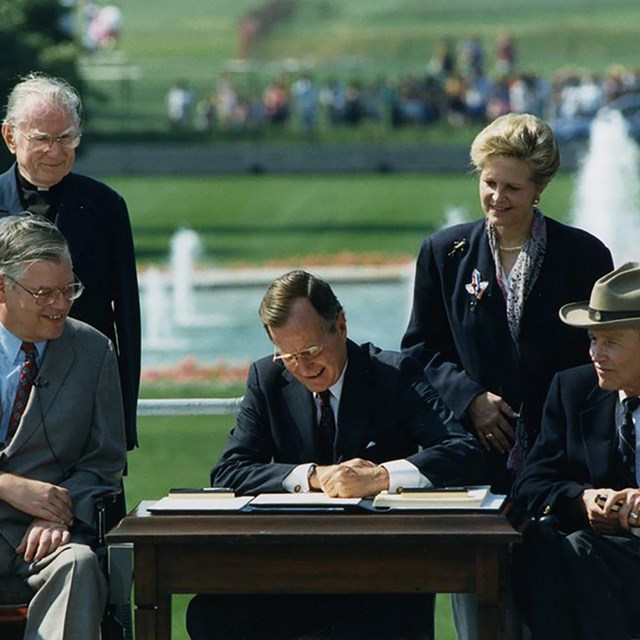 President GHW Bush signs the ADA 1990. National Museum of American History photo