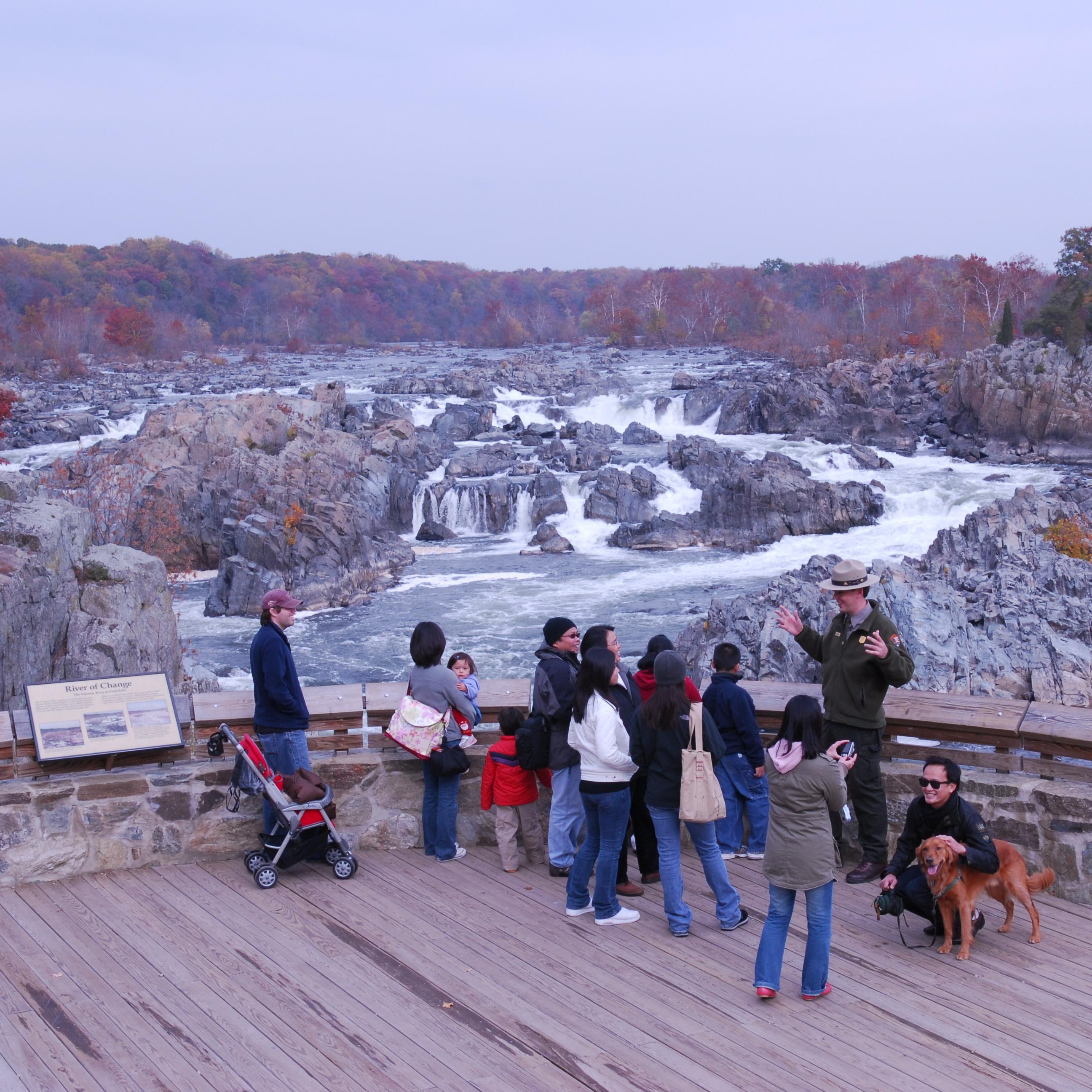 Visitors view waterfalls from an overlook.