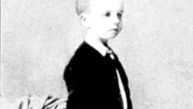 Black and white standing portrait of Elliot at age 5. 