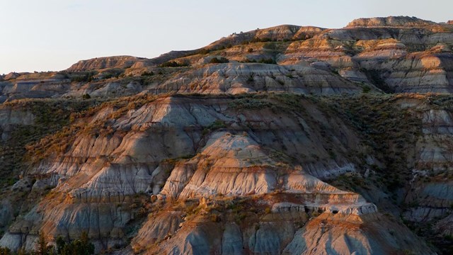 Shadowed, striped buttes that engulf the entire image.