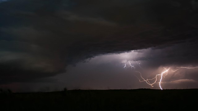 Lightning crackles amid dark skies.