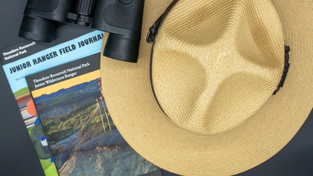 Ranger hat, binoculars, and Junior Ranger books.