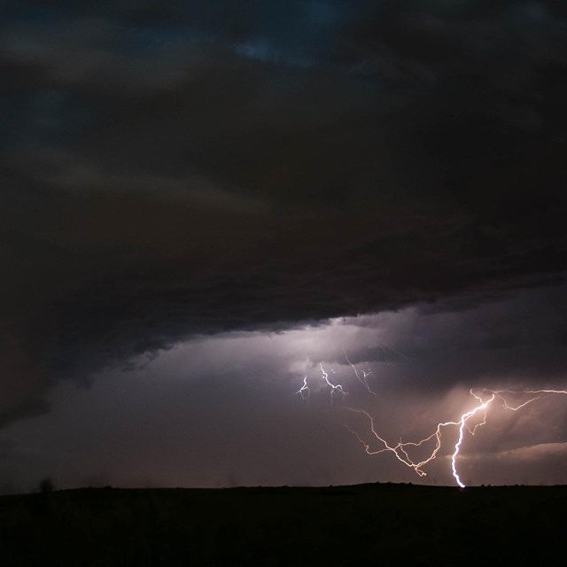 Lightning crackles amid dark skies.
