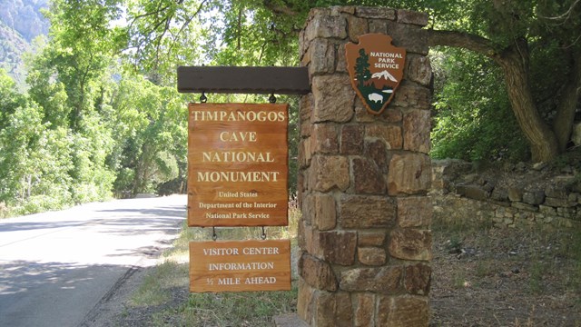 Welcome sign for Timpanogos Cave on the side of the rode. 