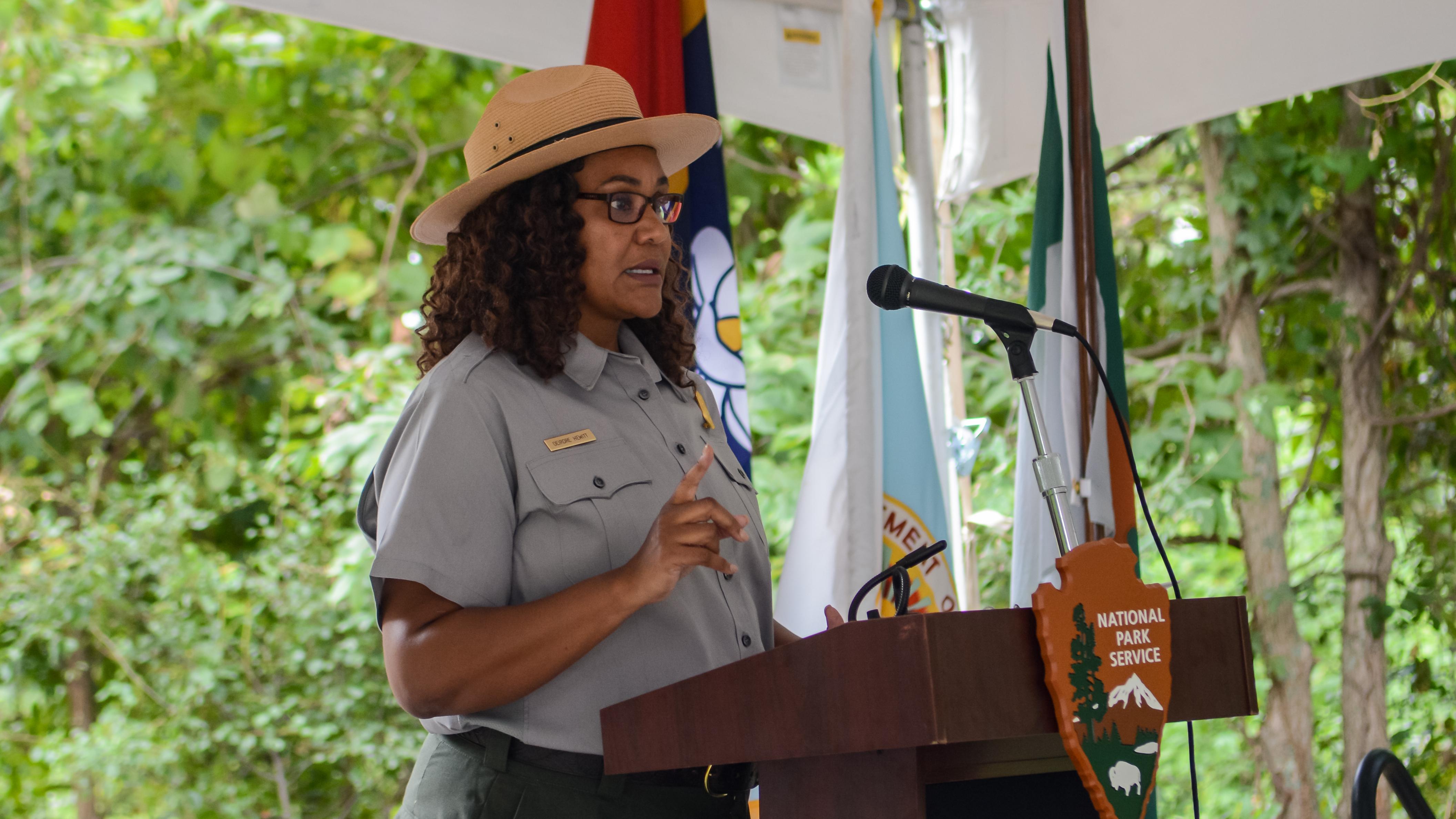 Ranger standing at a podium speaking into a microphone