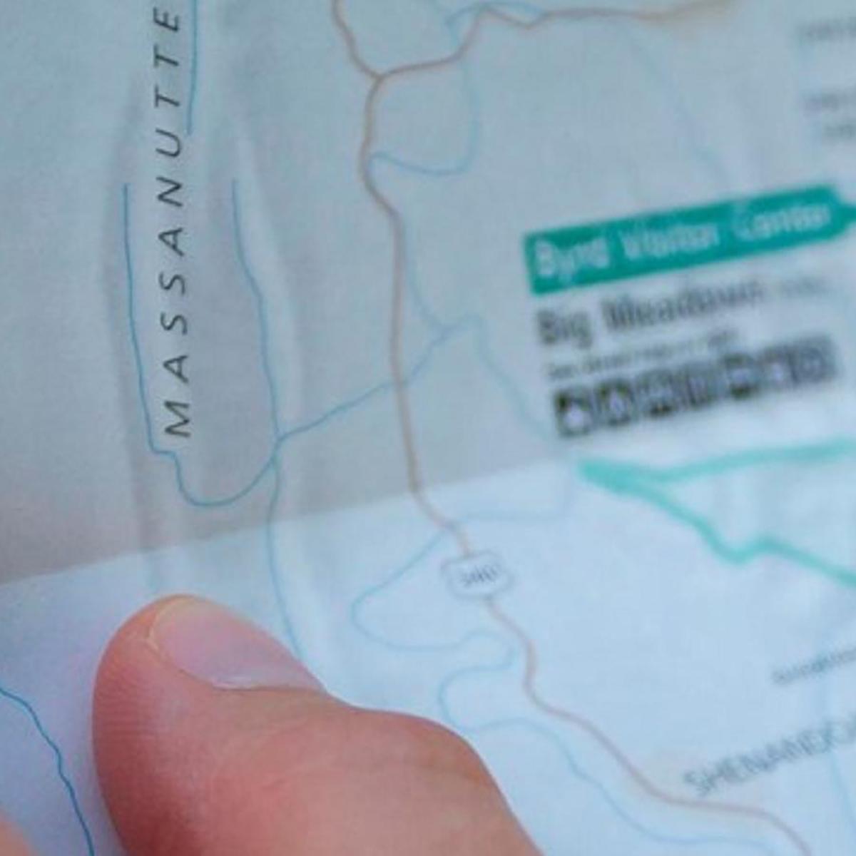 Closeup of a hand holding a park map. 
