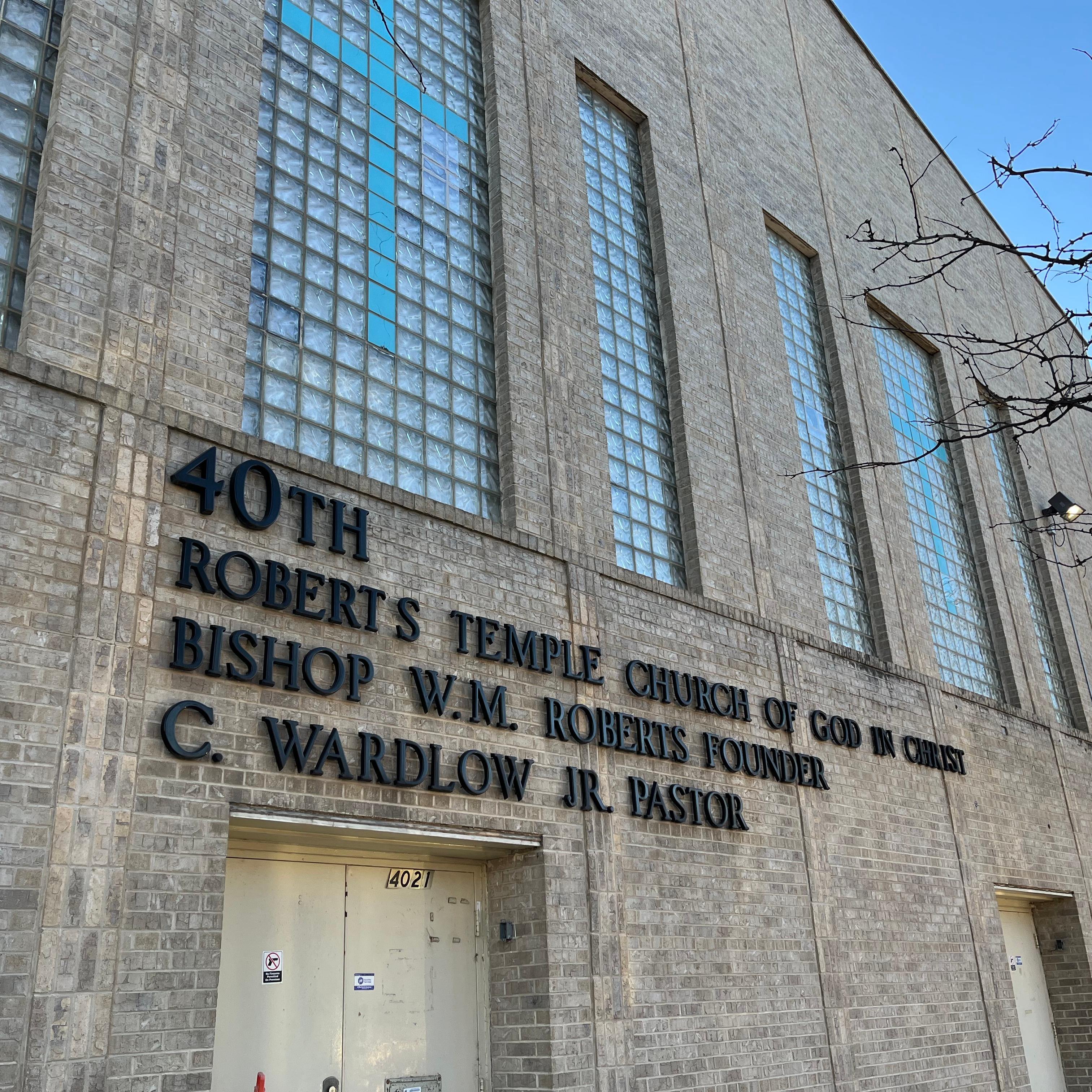 Exterior of a stone building with large glass windows