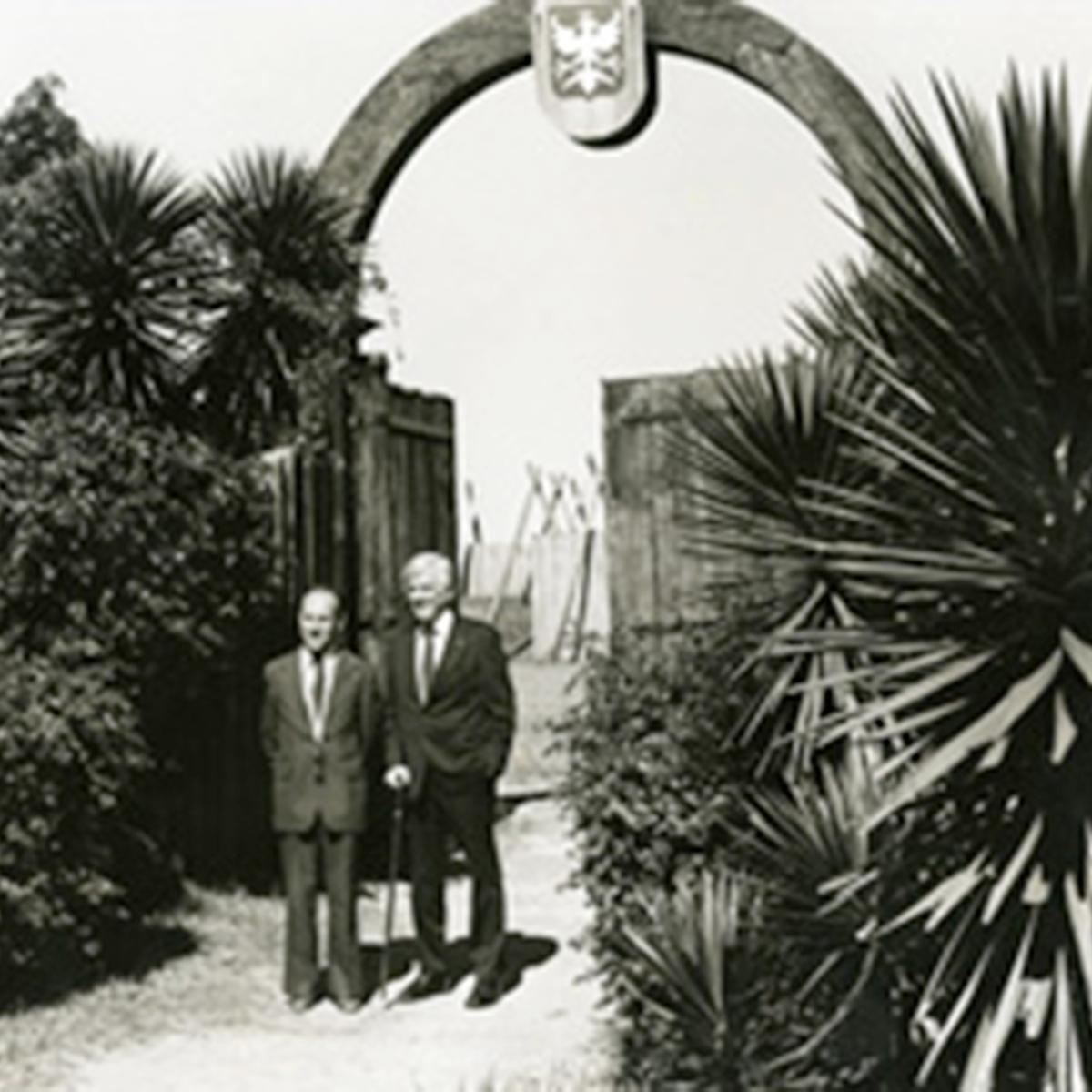 black and white image of two men at gate to Fort Caroline model 
