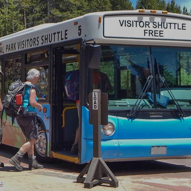 tourists get on a bus in Rocky Mountain National Park