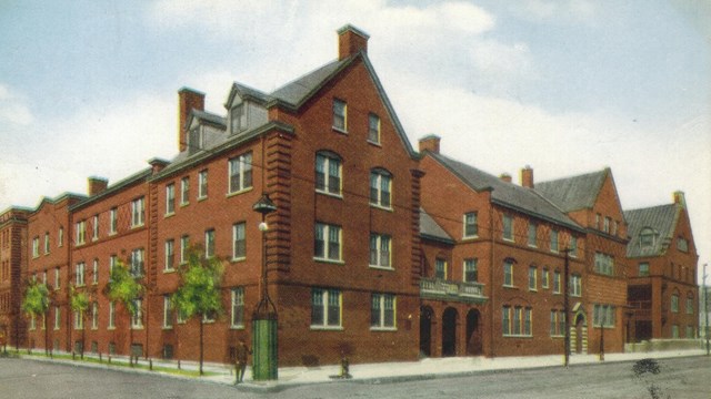Postcard of large brick building. 