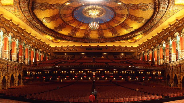 Inside of an ornate theatre. 
