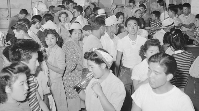 A view showing part of the crowd at general store Number 1 at this War Relocation Authority center w