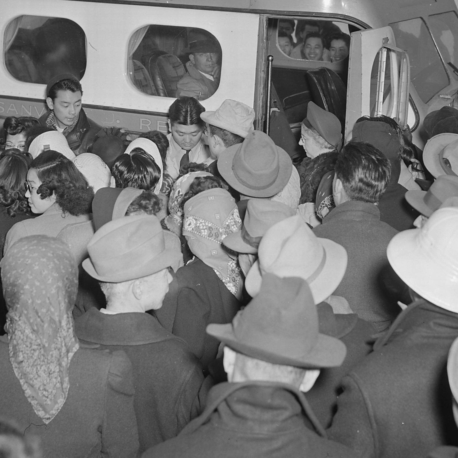 A large group of friends wish bon voyage to a group of eleven evacuees, who are leaving the center