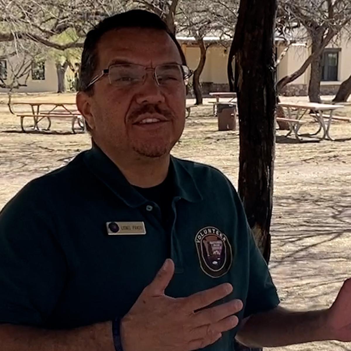 volunteer in the shade of cooking ramada
