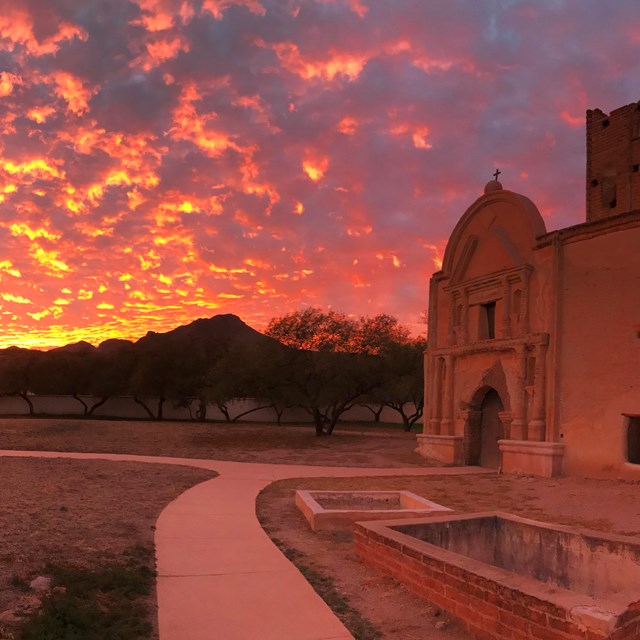 orange and pink sky with church in foreground