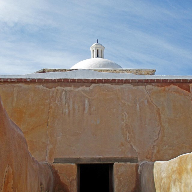 Photograph of adobe walls and doorway.