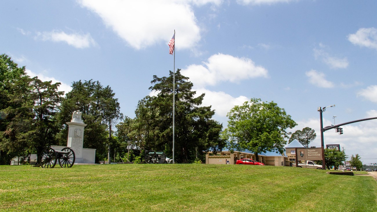 Two canons in front of a stone monument.