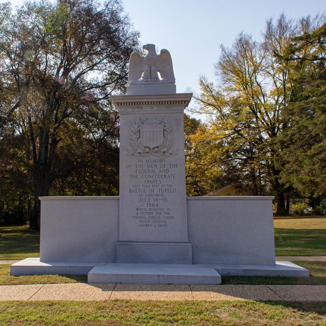 A stone monument with an eagle at the top, commemorating the Battle of Tupelo.