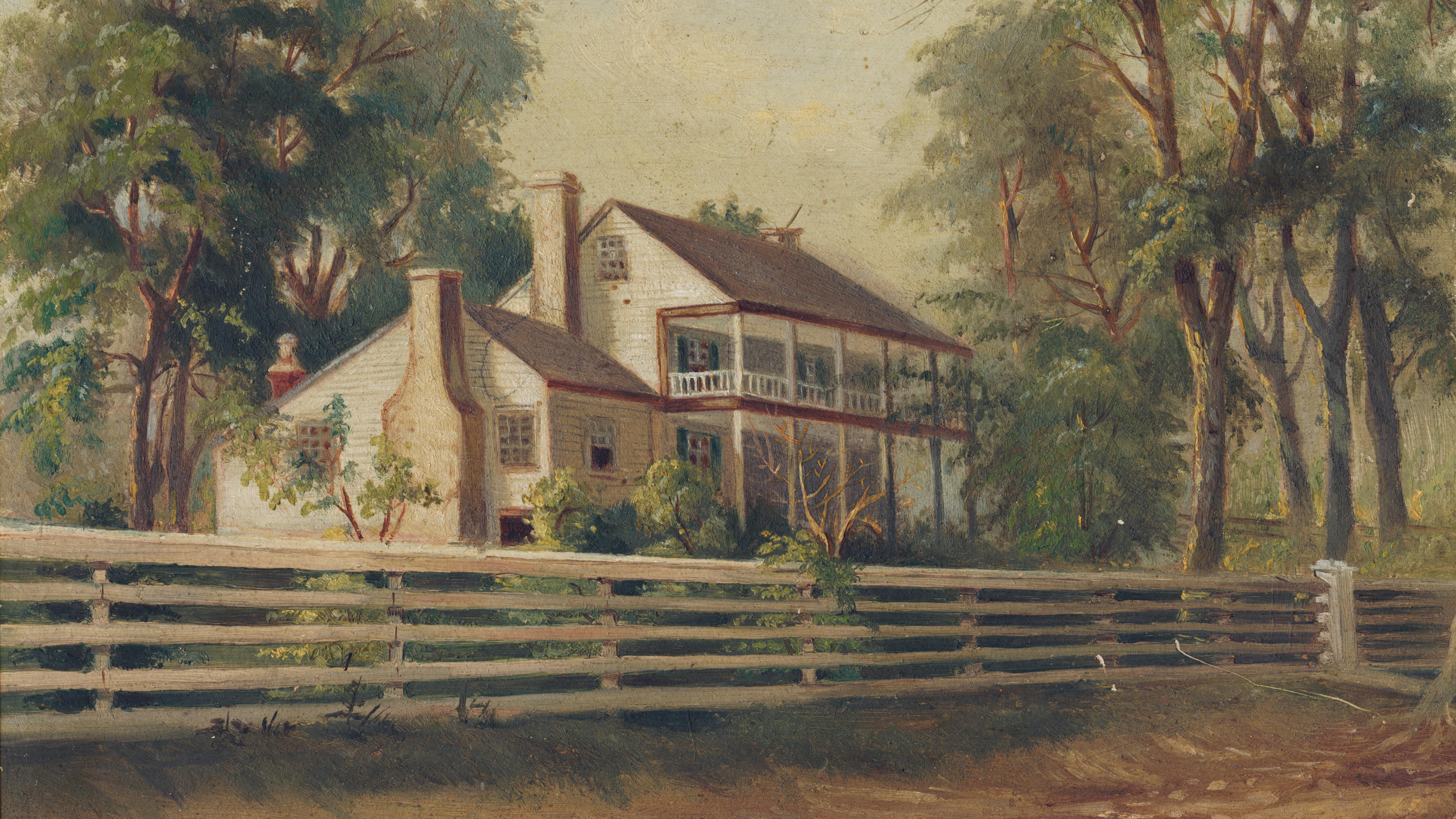 Two story frame house surrounded by trees and a picket fence. 