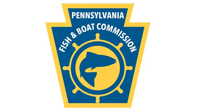 Logo for Pennsylvania Fish & Boat Commission: blue keystone outlined in yellow with fish in circle