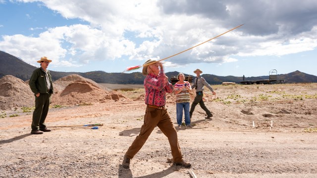 A man throws an atlatl during a ranger-guided cultural demonstration program.