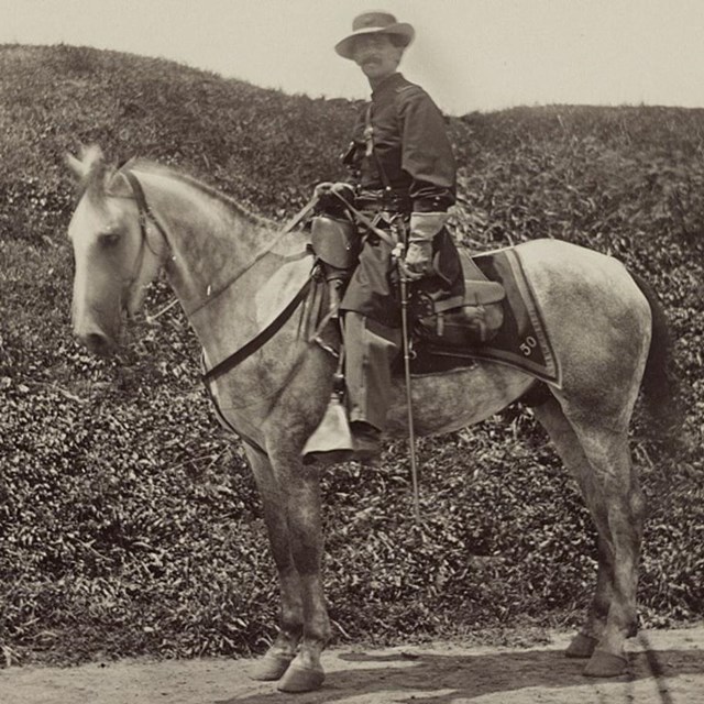 A Union officer on a white horse.