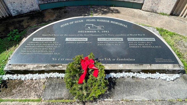 A semicircular plaque set into a concrete base.