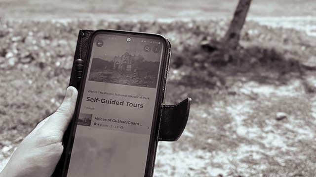 A phone open to the self-guided tour page for War in the Pacific National Historical Park.